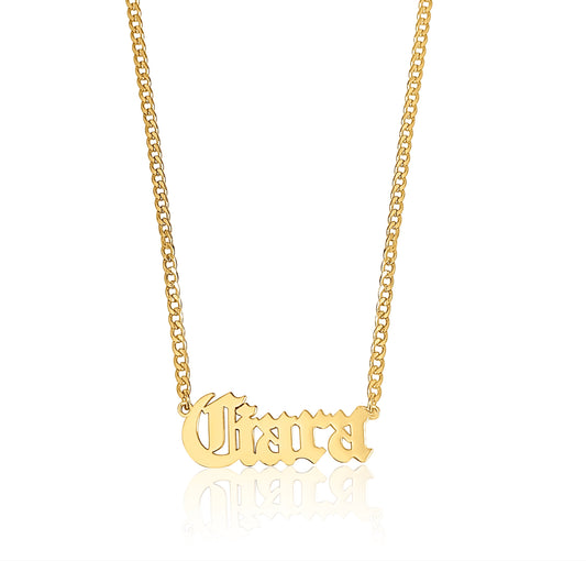 A gold-plated necklace with the name 'Ciara' engraved in Old English script, displayed against a white background.